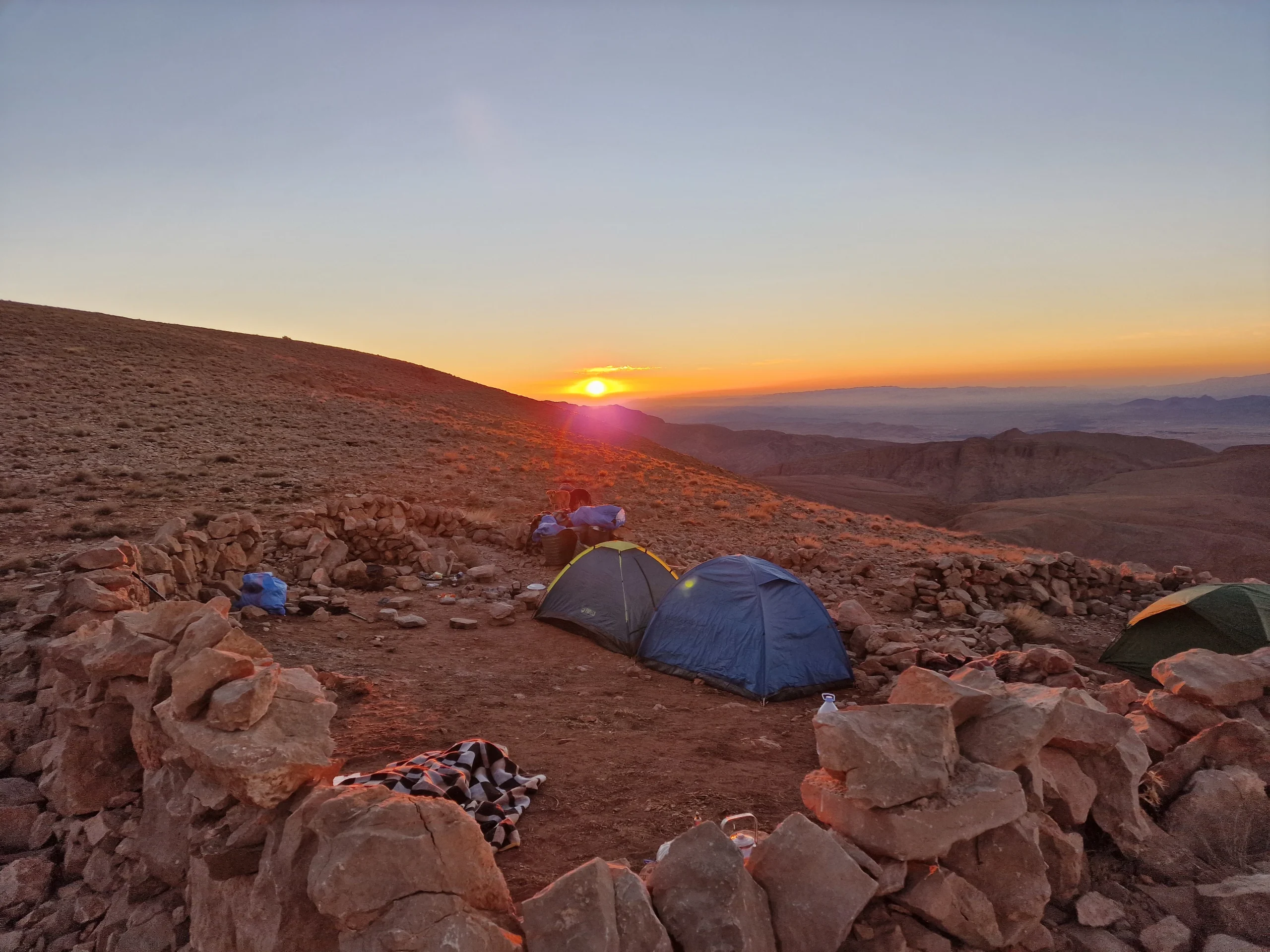 Sunset over the Atlas Mountains Morocco with golden light illuminating the peaks and valleys