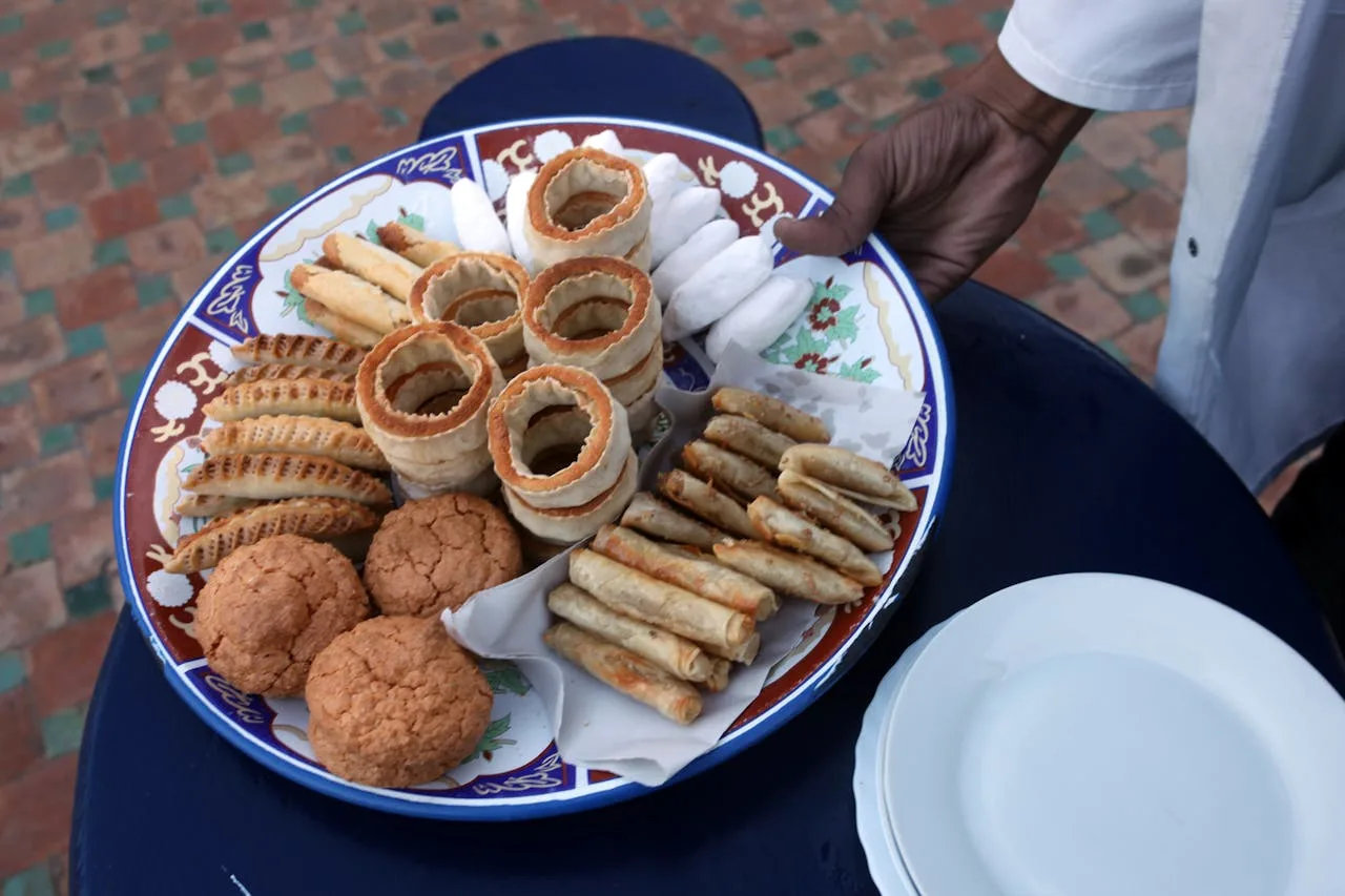A beautifully presented Moroccan breakfast spread with coffee, pastries and fresh fruits in a cafe setting