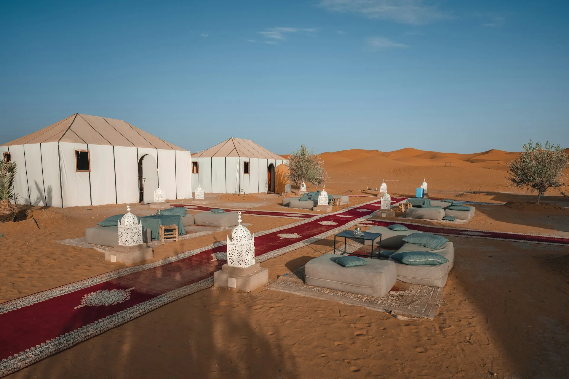 Berber camp at night glowing Khaima tents, fire pit, Milky Way visible overhead, warm and intimate atmosphere