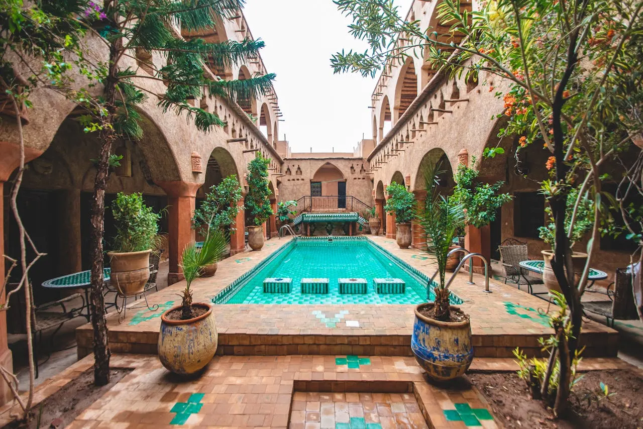 Traditional Moroccan riad courtyard with fountain and colorful tilework in Ouazrzazate