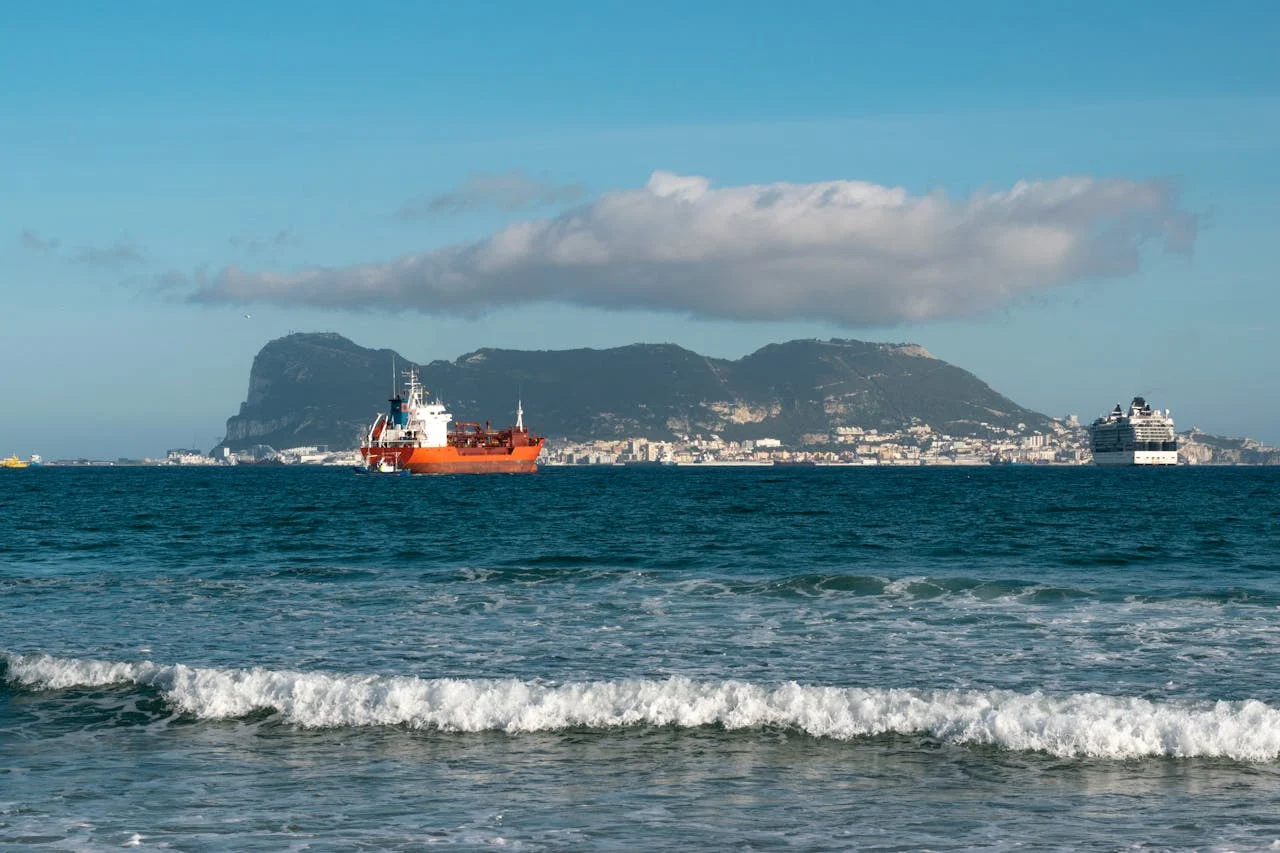 View of the Strait of Gibraltar with ferries crossing between Tangier, Morocco and Spain with both continents visible